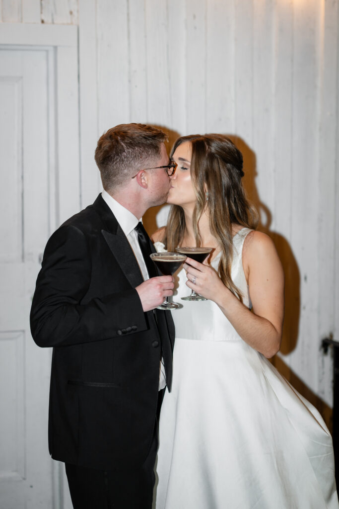 A bride and groom drinking espresso martinis at their wedding reception at Primrose Cottage in Roswell, Georgia