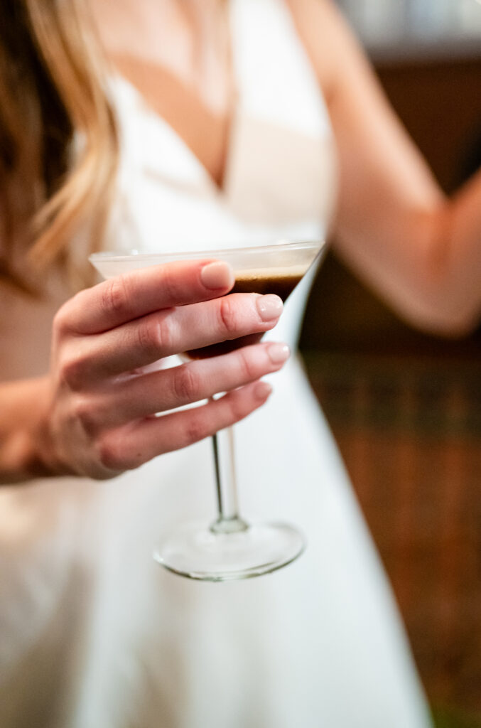 A bride and groom drinking espresso martinis at their wedding reception at Primrose Cottage in Roswell, Georgia