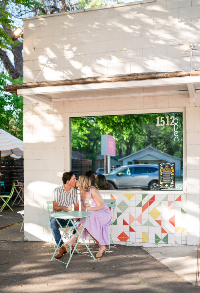 An engaged couple taking their engagement photos at an ice cream shop in Austin Texas