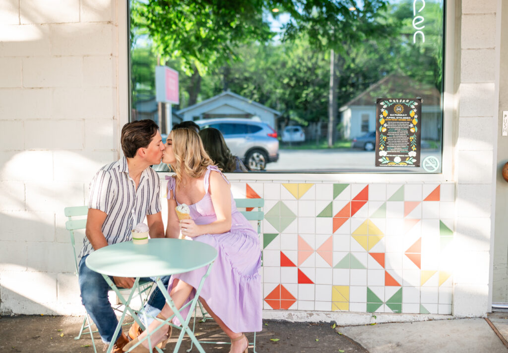 An engaged couple taking their engagement photos at an ice cream shop in Austin Texas