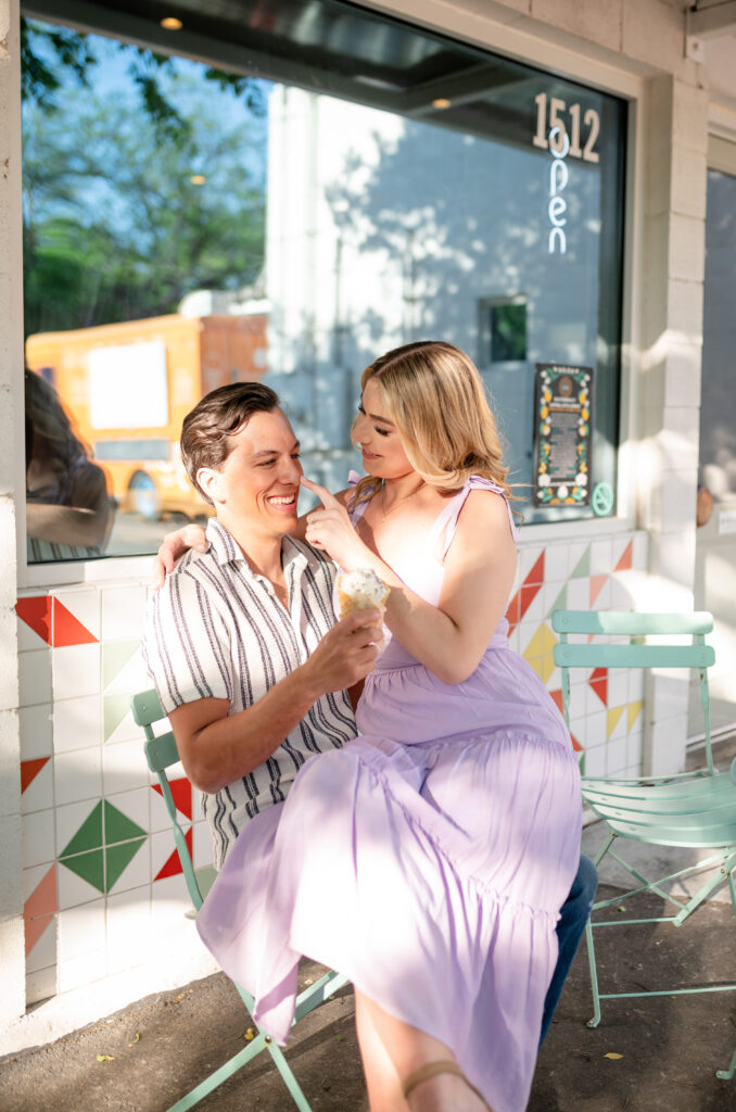 An engaged couple taking their engagement photos at an ice cream shop in Austin Texas