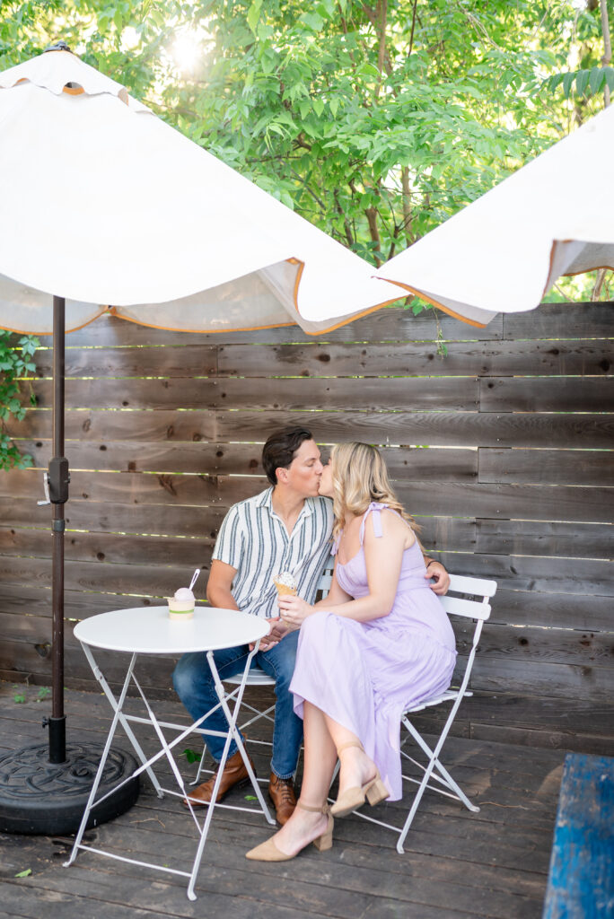 An engaged couple taking their engagement photos at an ice cream shop in Austin Texas