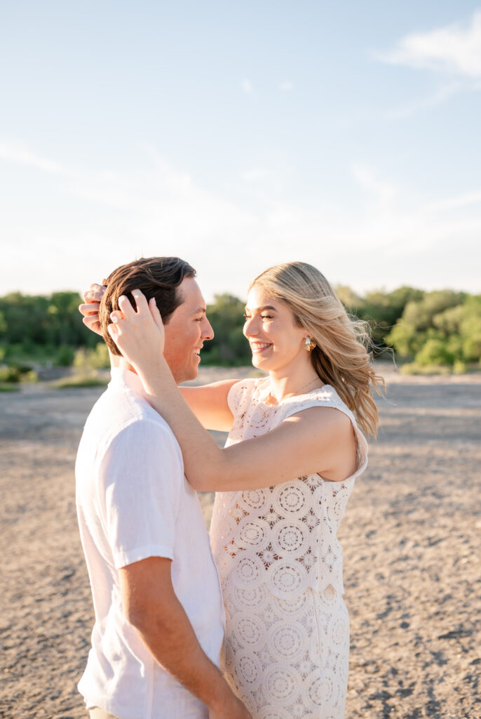 An engaged couple taking their engagement photos at Mckinney Falls State Park in Austin Texas