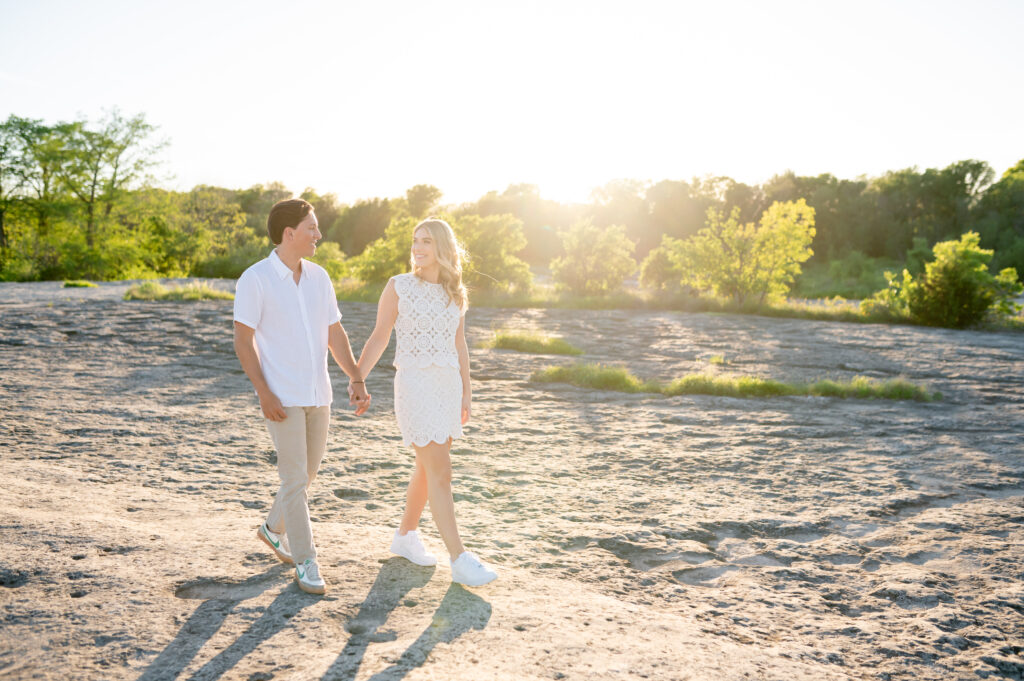 An engaged couple taking their engagement photos at Mckinney Falls State Park in Austin Texas