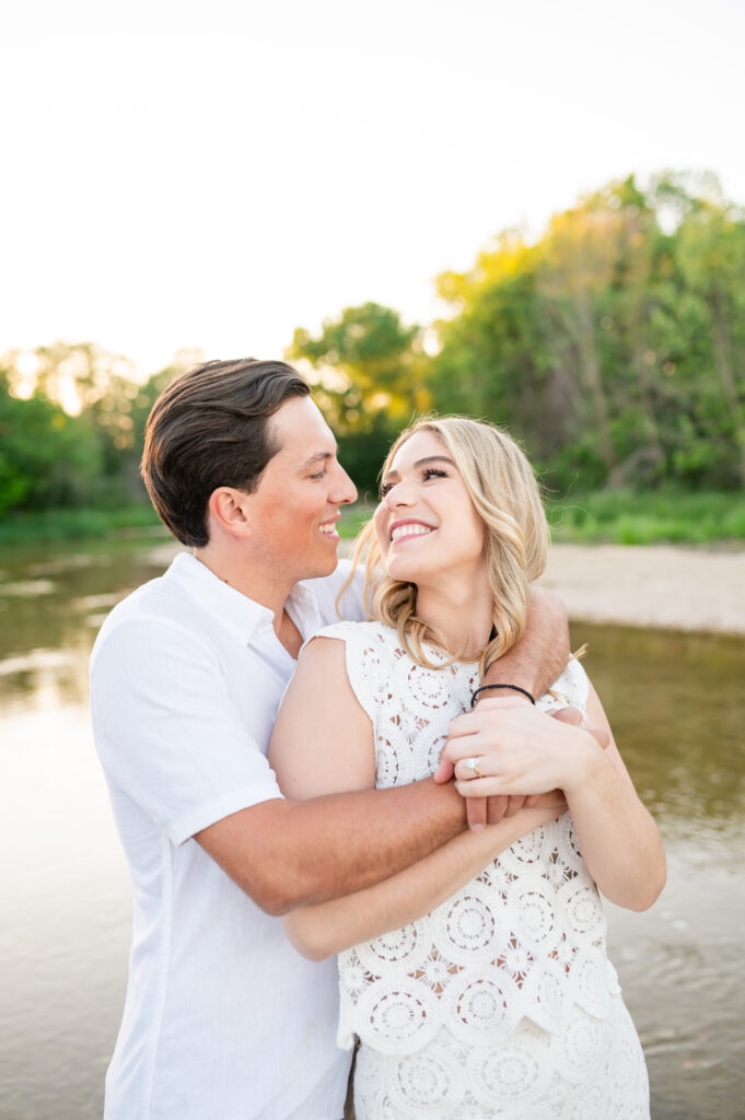 An engaged couple taking their engagement photos at Mckinney Falls State Park in Austin Texas