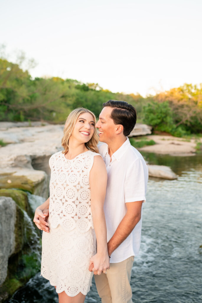 An engaged couple taking their engagement photos at Mckinney Falls State Park in Austin Texas