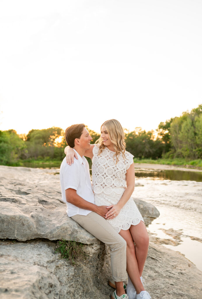 An engaged couple taking their engagement photos at Mckinney Falls State Park in Austin Texas