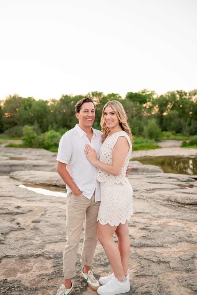 An engaged couple taking their engagement photos at Mckinney Falls State Park in Austin Texas