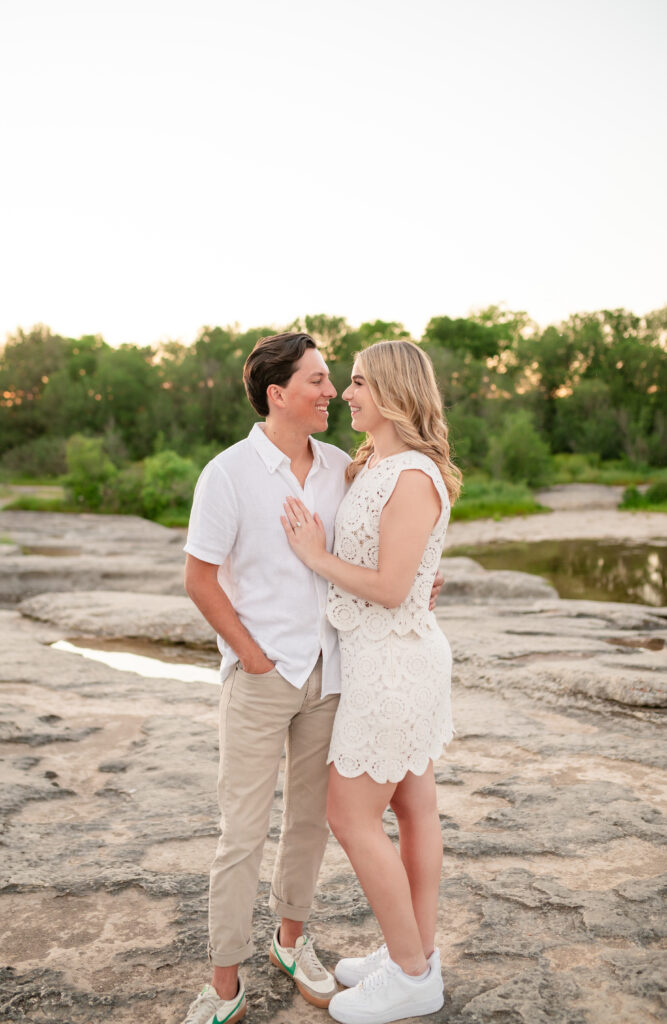 An engaged couple taking their engagement photos at Mckinney Falls State Park in Austin Texas