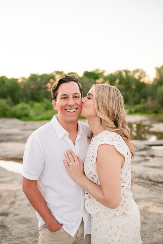 An engaged couple taking their engagement photos at Mckinney Falls State Park in Austin Texas