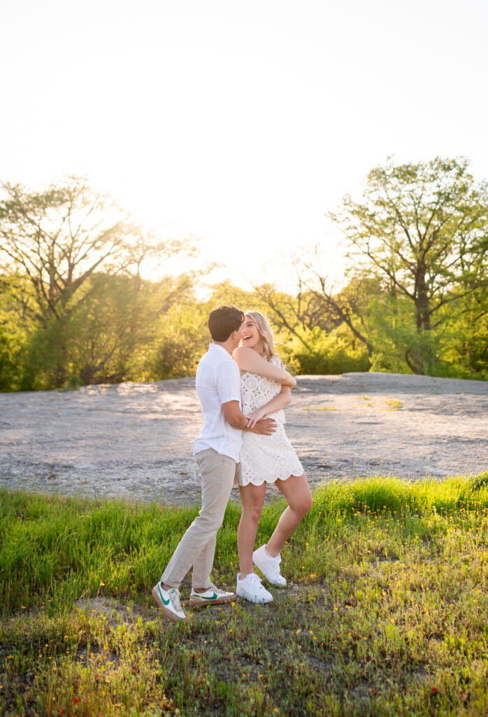 An engaged couple taking their engagement photos at Mckinney Falls State Park in Austin Texas