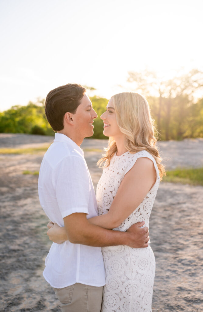 An engaged couple taking their engagement photos at Mckinney Falls State Park in Austin Texas